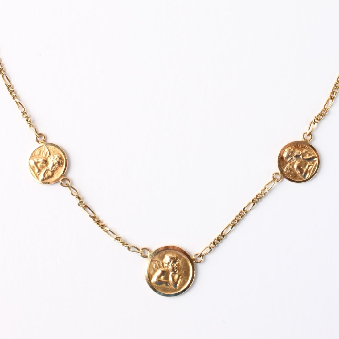 14K Necklace: Vintage Italian Delicate 14 Karat Yellow Gold Necklace with Three Relief Cherub Pendants after: Raphael. Stamped Italy 14K and 585 to clasp. Measures 16-1/4" L. Approx. weight: 6.69 grams. Kodner