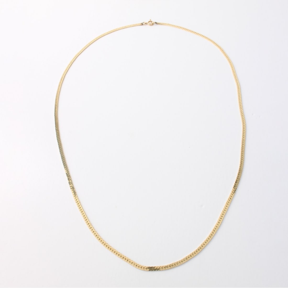 14K Necklace: Vintage 14 Karat Yellow Gold Herringbone Link Necklace. Clasp stamped 14K. Measures 20" L, 2mm W. Approx. weight: 7.15 grams. Kodner Galleries offers phone and absentee bidding at a low, flat 21% buye