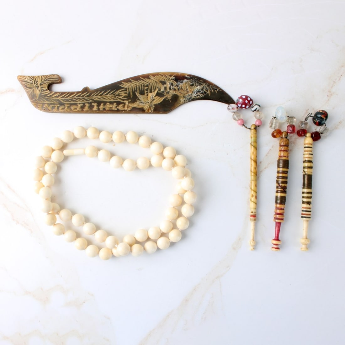 Collection of Vintage Articles: Collection of Five (5) Carved and Painted Vintage Articles. Including three (3) lace bobbins, measures: 4-1/2" long, one (1) beaded necklace, measures: 24" long, one (1) caved letter opener, measures: