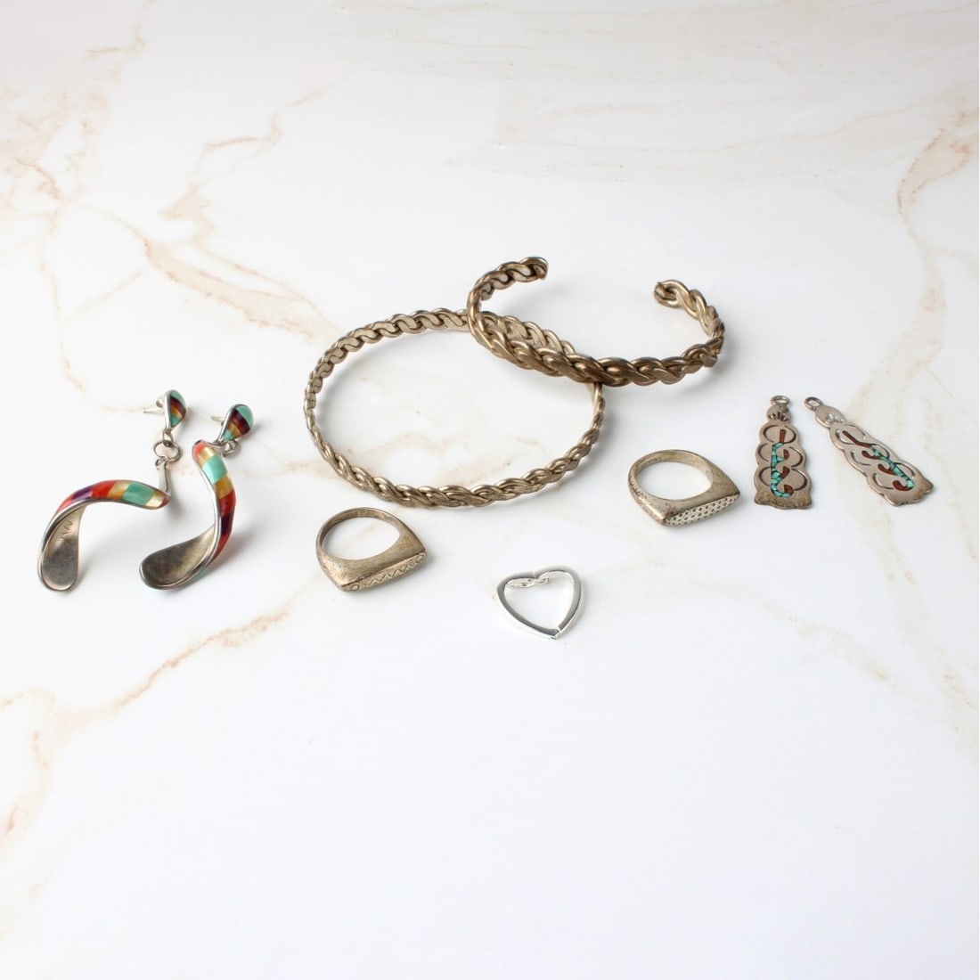 Sterling Silver Jewelry: Sterling Silver Jewelry. Consisting of one (1) pair of sterling silver twist earrings, measures: 1-5/8" long, one (1) heart shape hinged pendant, measures: 5/8" long, one (1) pair of earrings with