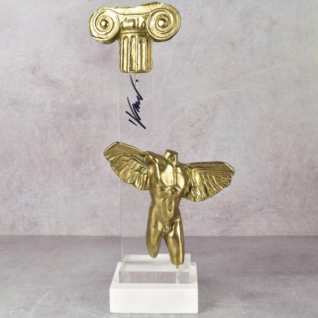 Yanni Souvatzoglou, Greece (b. 1946): Yanni Souvatzoglou, Greece (b. 1946) Brass Marble Angel Sculpture on Lucite and a White Marble Base. Signed on the lucite upright. Angel measures: 5-1/2" high, end to end wing tip, measures: 6",