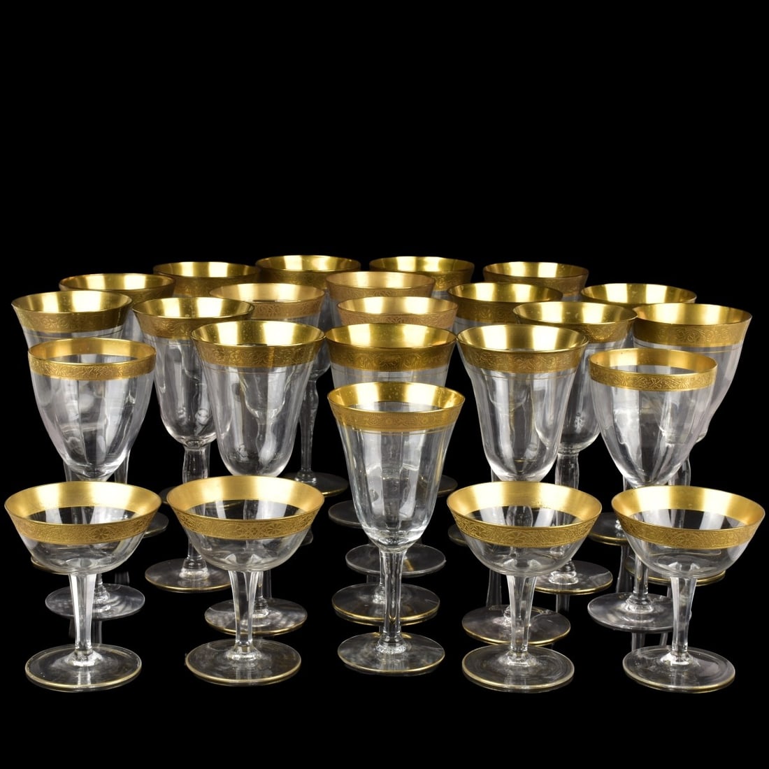Vintage Gold Rimmed Glasses: Assortment of Twenty-four (24) Vintage Gold Rimmed Glasses. Slight differences in gold rim patterns and glass textures. Tallest measures: 8-3/4" high, 3-3/8" diameter, champagne-sherbet coups,