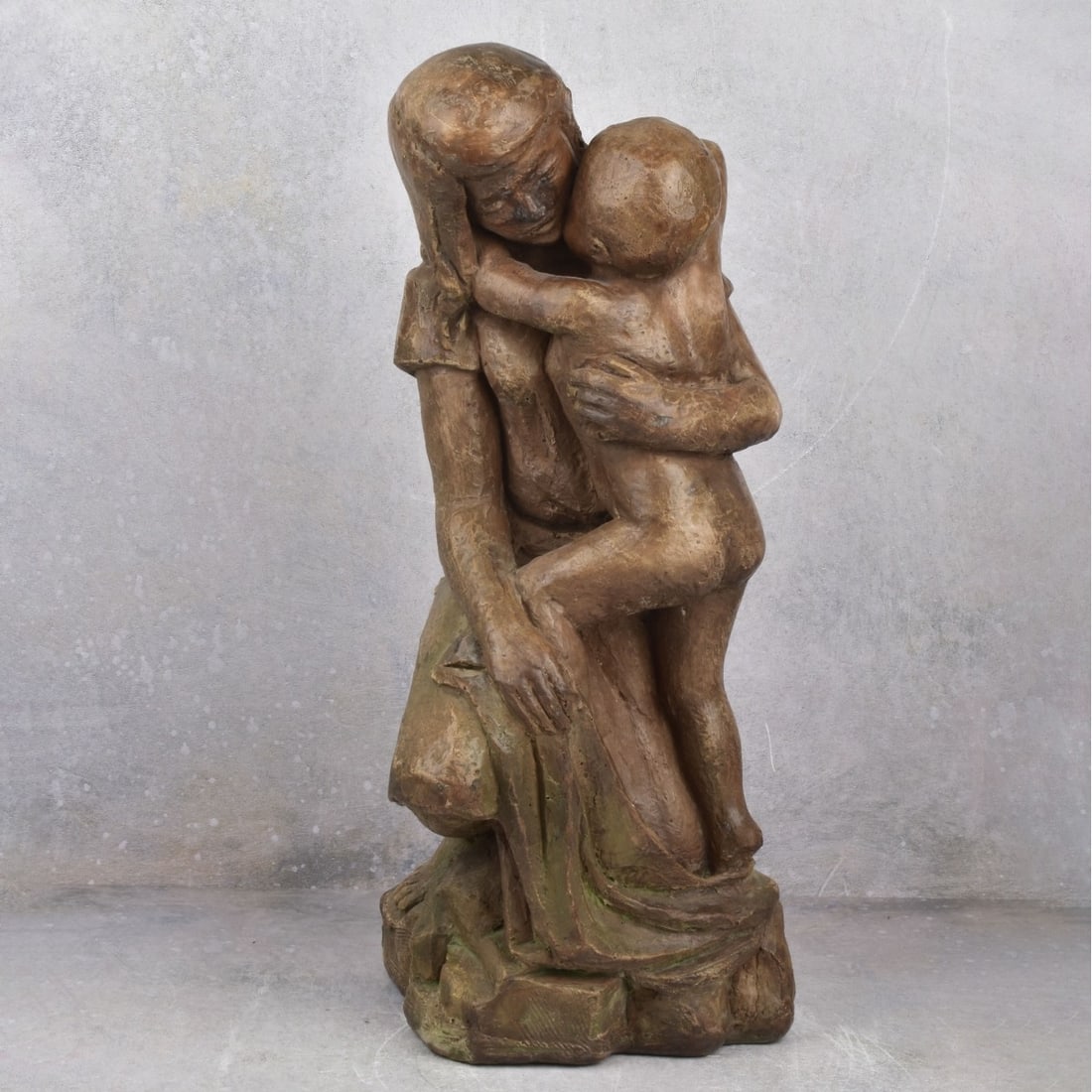 Composition Figurine of a Mother and Child: Composition Figurine of a Mother and Child. Measures" 18-1/2" H, 7" W, 10-1/2" D. Kodner Galleries offers phone and absentee bidding at a low, flat 21% buyer’s premium without surcharge or hidden