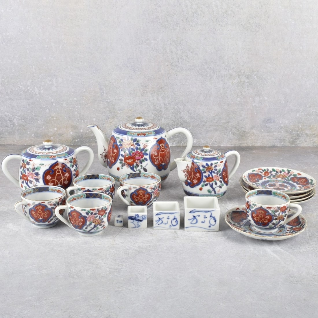 Fuki Choshun Nisho Tea Service & Sake Game: Fuki Choshun Nisho Tea Service with a Sake Game. Tea set consists of teapot, measures: 4-1/4" high, 7-1/4" wide, 4-1/4" deep, covered creamer, covered sugar, five (5) cups and saucers, all properly