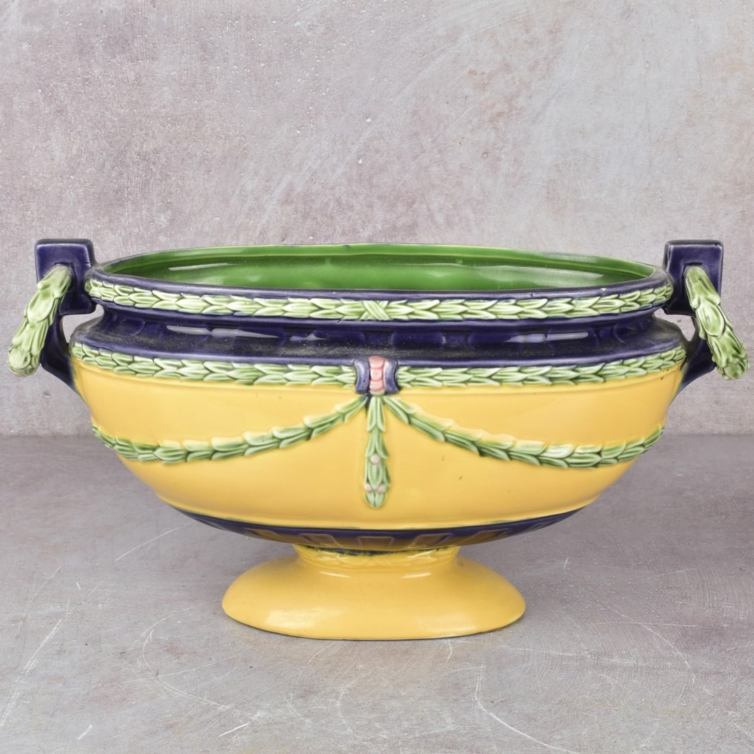 Antique Czechoslovakian Jardiniere: Antique Czechoslovakian Majolica Art Nouveau Style Jardiniere. Decorated with an attached floral ring to each end with hanging garlands. Molded "CZECHOSLOVAKIAN 8022" to the bottom. Measures: 5-1/2"