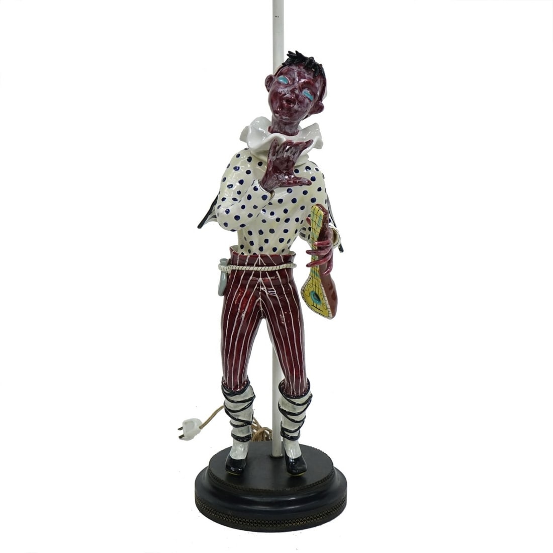 Mandolin Player Pottery Lamp: Large Continental Glazed Pottery Harlequin Mandolin Player Mounted as a Lamp. Figure measures 22" x 8-1/2" x 10". Overall measures 41" x 8-1/4". Kodner Galleries offers phone and absentee bidding at a