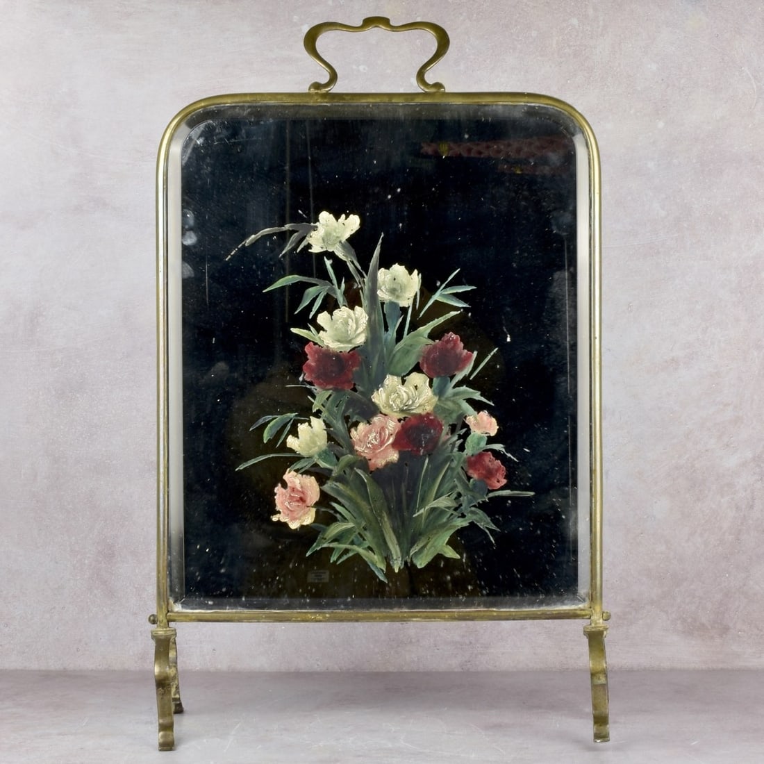 Antique Fire Screen: Antique Beveled Mirror and Brass Fire Screen with Hand Painted Flowers. Measures: 26-1/2" high, 17-1/4" wide, 7" deep. Kodner Galleries offers phone and absentee bidding at a low, flat 21% buyer’s