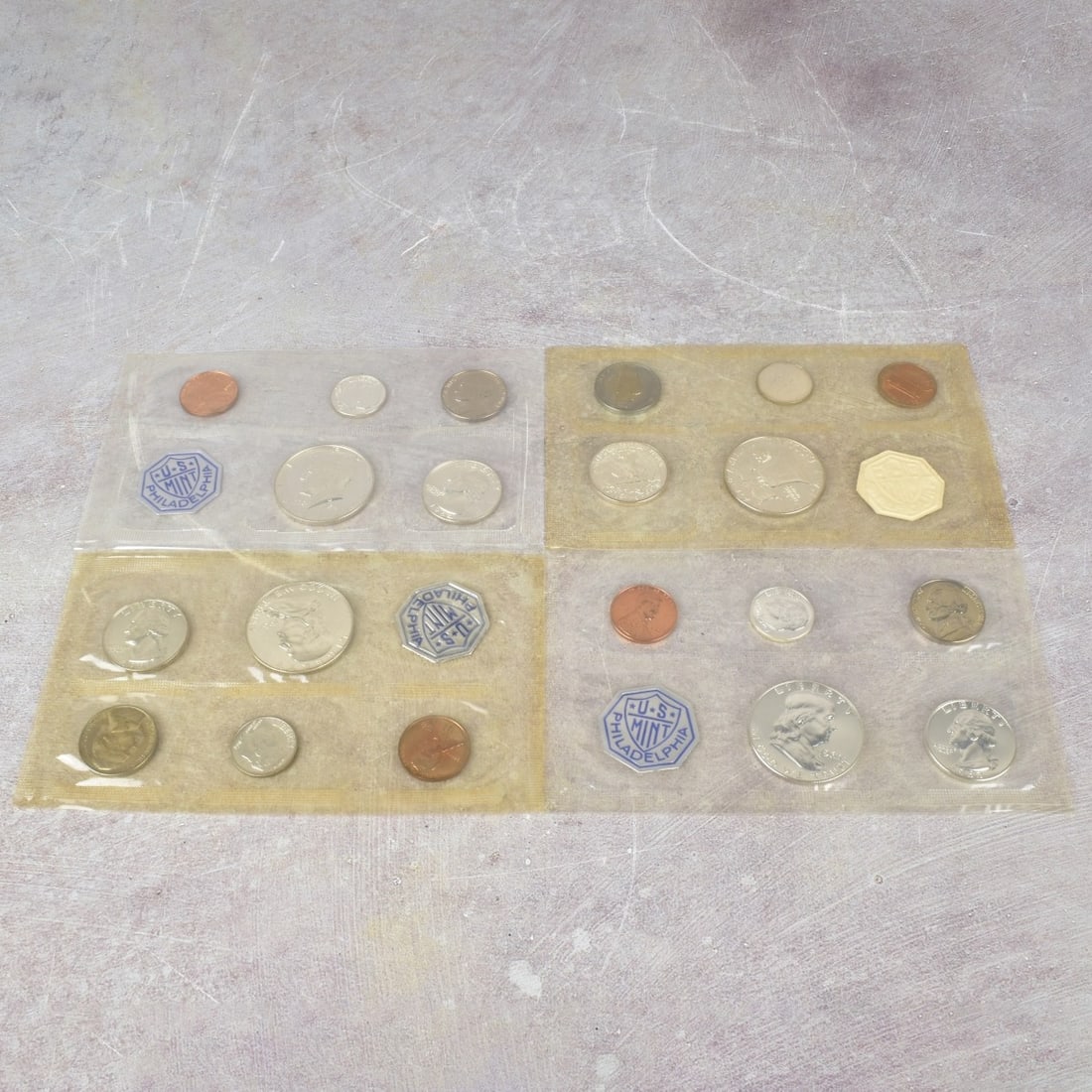 US Mint Proof Sets: Four (4) US Mint Proof Sets. Consisting of two (2) 1961, one (1) 1963 and one (1) 1964 set with each having five (5) coins per set with mixed denominations and struck at the Philadelphia mint.