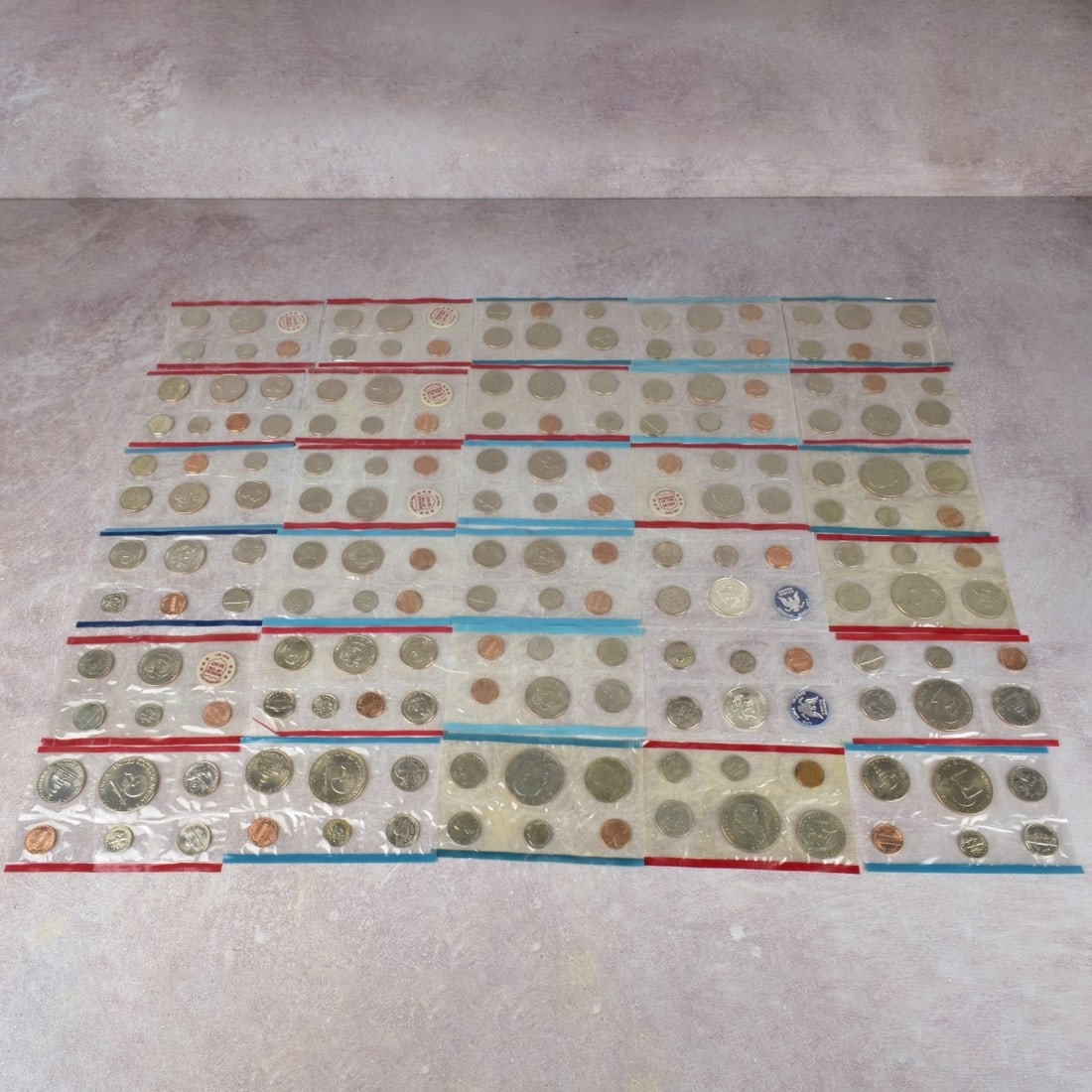 US Mint Proof Sets: Thirty (30) US Mint Proof Sets. Consisting of twenty-two (22) Kennedy half-dollar sets struck 1965 or latter and eight (8) Eisenhower dollar sets struck 1976 or latter with mixed denominations and