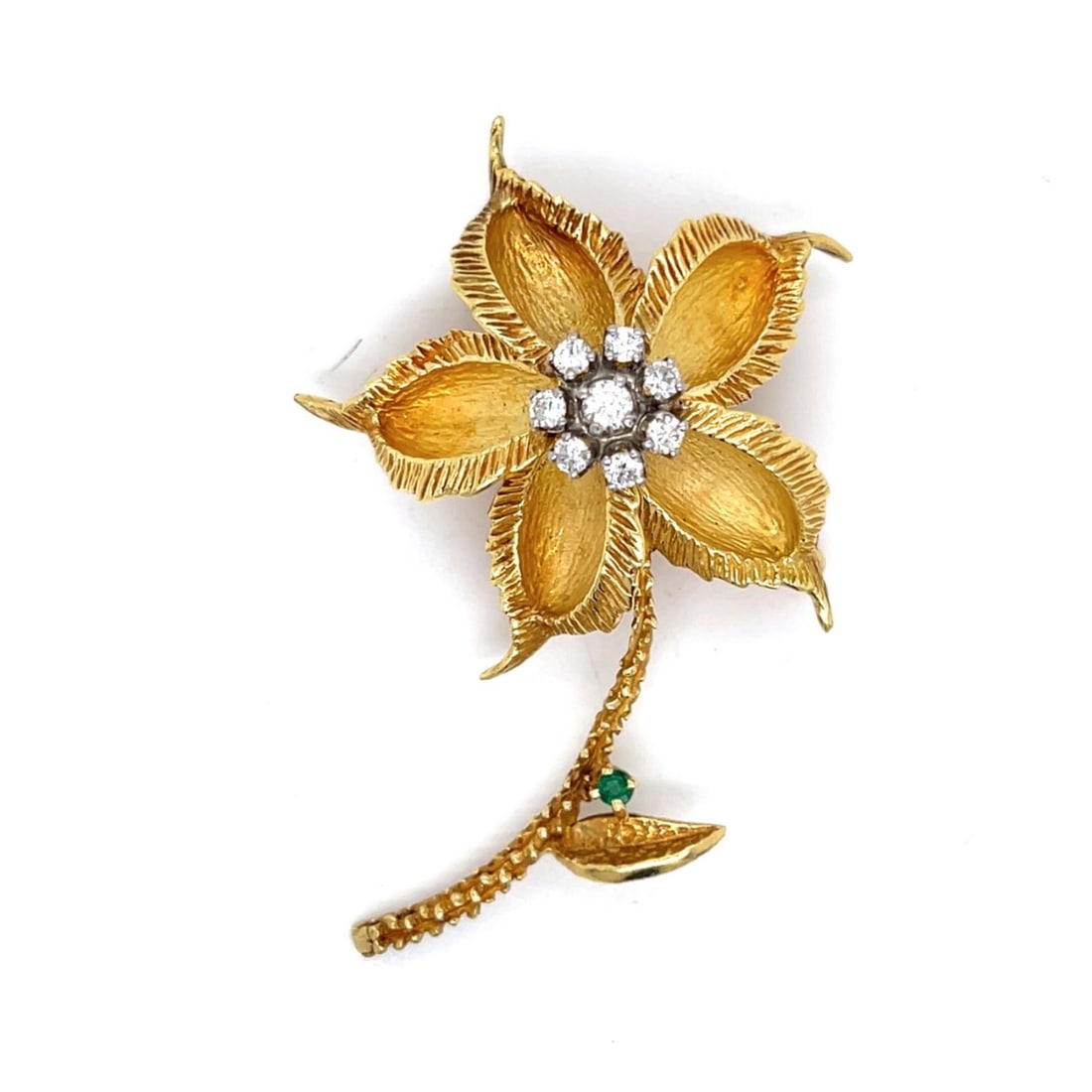 Cartier Diamond and 18K Flower Pin: Vintage Cartier Circa 1960s Approx. .55 Carat TW Round Brilliant Cut Diamond and 18 Karat Yellow Gold Flower Brooch with Small Emerald Accent. Signed. Diamonds F-G color, VVS-VS clarity. Measures
