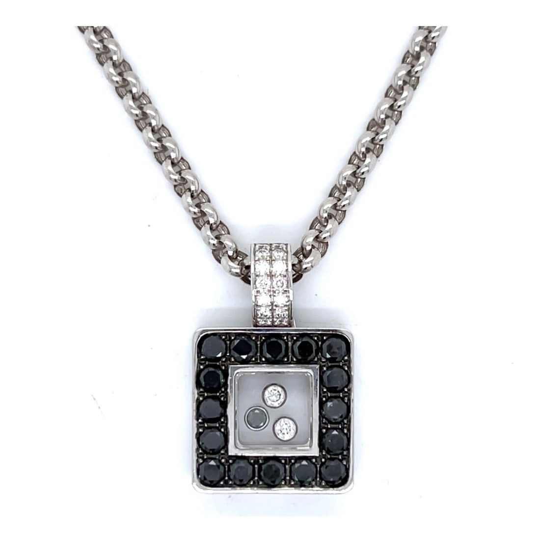 Chopard Diamond and 18K Necklace: Chopard 2.21 Carat TW Black and White Diamond and 18 Karat White Gold Pendant Necklace. White diamonds D-F color, VVS-VS clarity. Signed. Pendant measures 3/4" L, chain measures 16" L. Approx. total