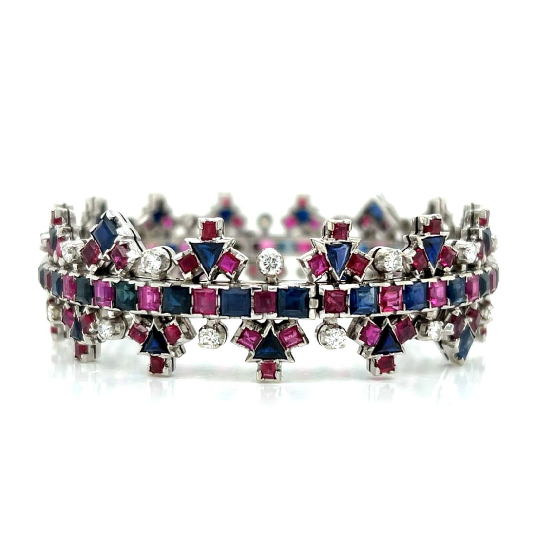 Diamond, Sapphire, Ruby and 18K Bracelet: Vintage Circa 1960s Retro Modern Design Approx. 1.50 Carat TW Round Brilliant Cut Diamond, 20.0 Carat TW Baguette Cut Rubies and Sapphires and 18 Karat White Gold Bangle Bracelet. Diamonds G-H color,