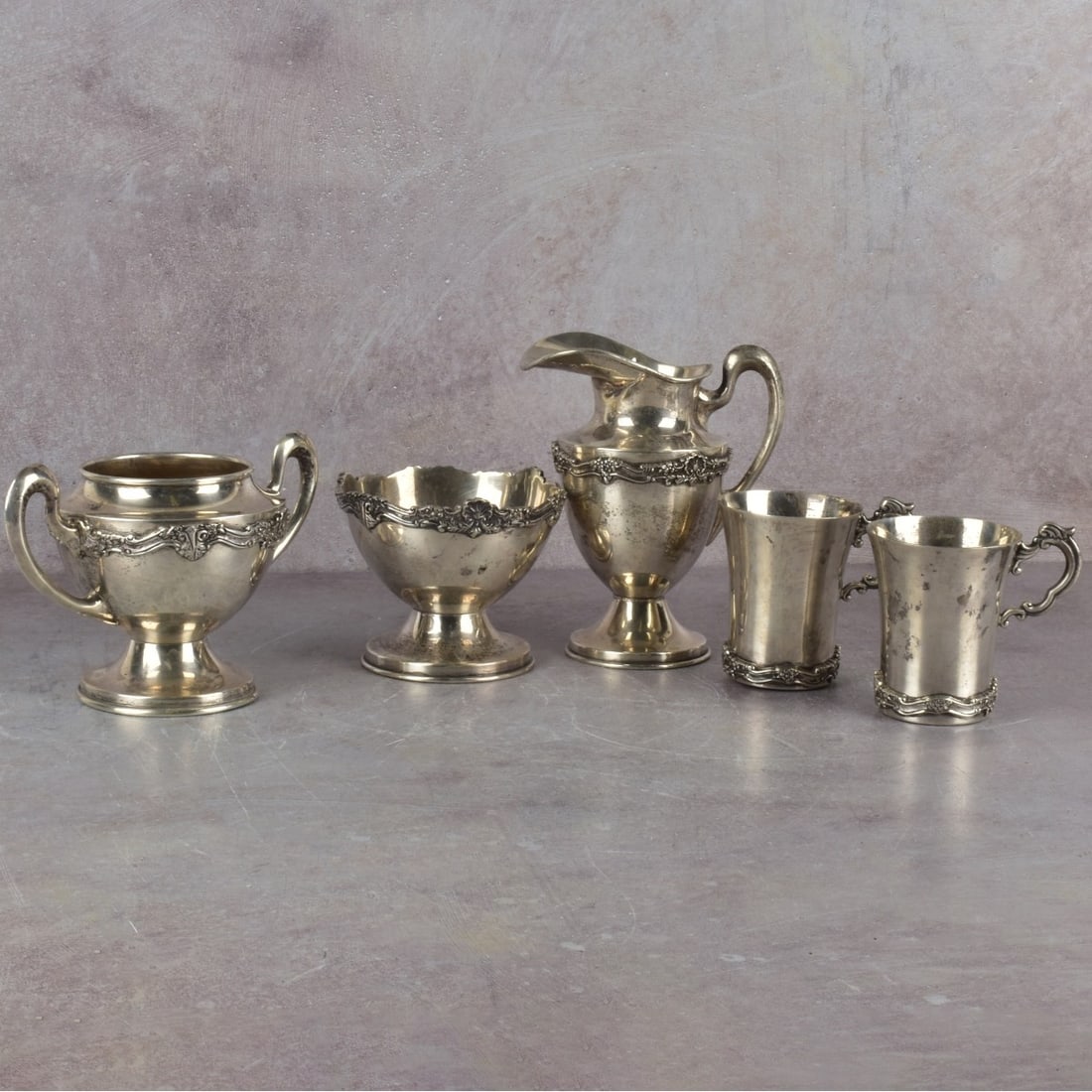 Sterling Tea Set: Vintage Mexican Conquistador Sterling Silver Tea Set Comprising Open Sugar Bowl, Milk Pitcher, Waste Bowl and Two Beakers. Signed, stamped Sterling Mexico 925/1000.Milk pitcher measures 6" H, 5" W.