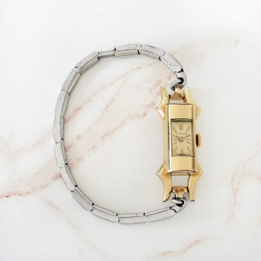 Retro Turler Watch: Lady's Retro Circa 1950s Turler Gold Plated Tubular Shape Watch with a 10K White Gold Filled Stretch Bracelet. Manual wind movement. Case measures 23.5 x 11mm. Approx. gross weight: 17.64 grams.