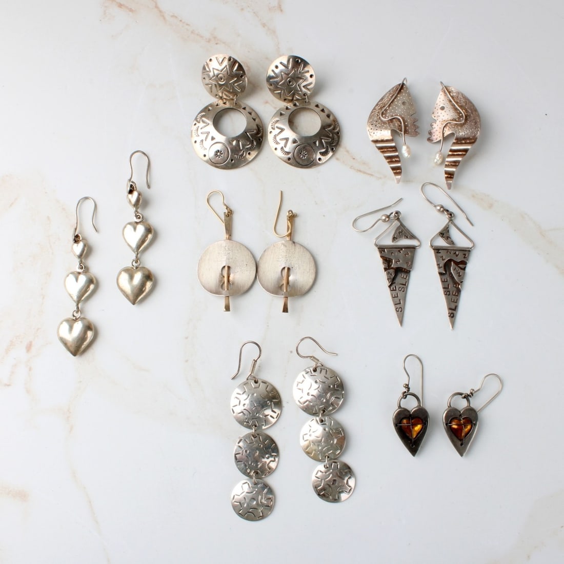 Sterling Silver Earrings: Seven Pair of Vintage Modern Sterling Silver Earrings. One pair accented with small baroque pearls another pair with yellow gemstones possibly citrines Several are signed and marked sterling or 925.