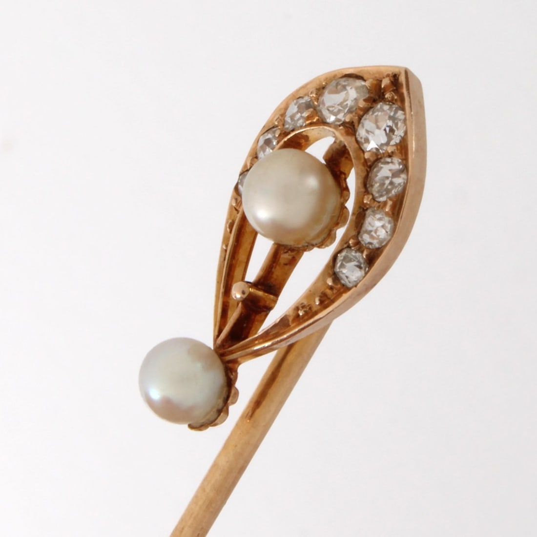 Diamond, Pearl and 14K Stickpin: Antique Mine Cut Diamond, Pearl and 14 Karat Yellow Gold Stickpin. Diamonds G-H color, VS clarity. Measures 1-1/2" L, 3/8" W. Approx. weight: 1.29 grams. Kodner Galleries offers phone and absentee