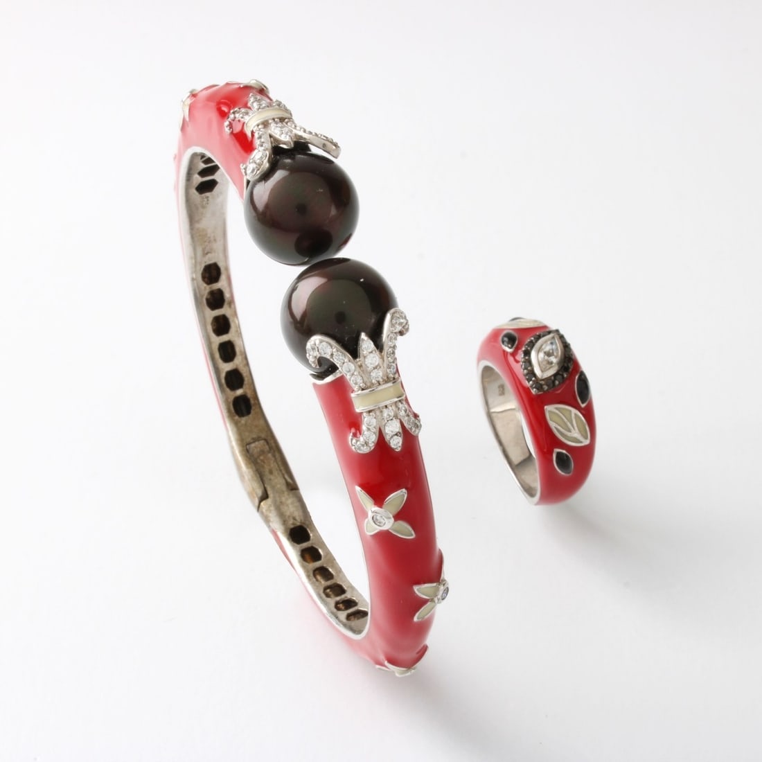 Sterling Silver Bracelet and Ring: Sterling Silver, Pearl, Red Enamel and Cubic Zirconia Hinged Bangle Bracelet and Ring. Stamped 925. Ring size 7, bracelet measures 6-1/2" interior circumference. Approx. total weight: 39.12 grams.