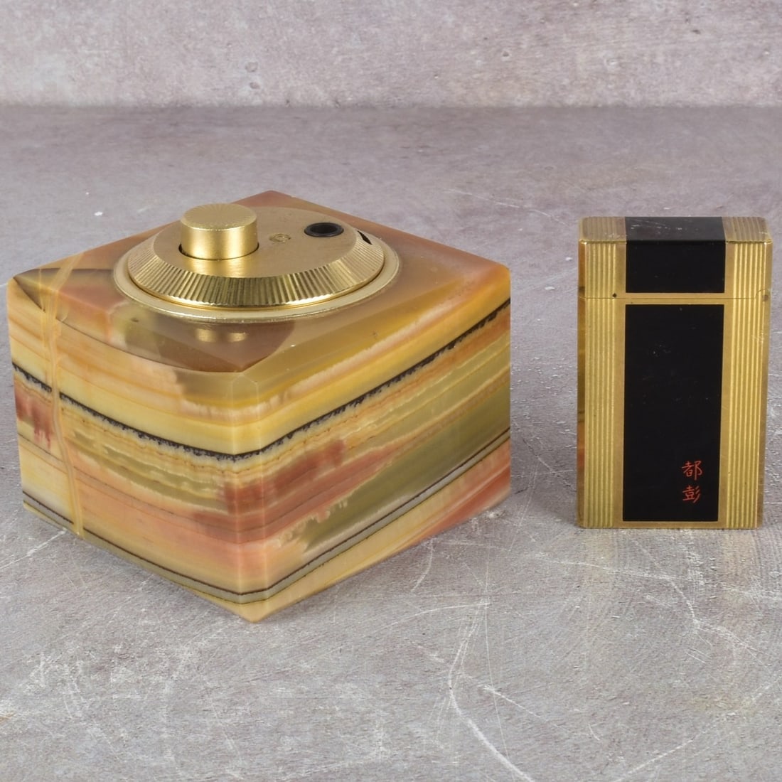 St. Dupont and Jbelo Lighters: Two (2) Vintage Lighters. One (1) St. Dupont Lighter Gold Plated Chinese Lacquer Paris, France, Circa 1970, measures: 2-1/4" high, one (1) German Jbelo table lighter with marble stand having beveled