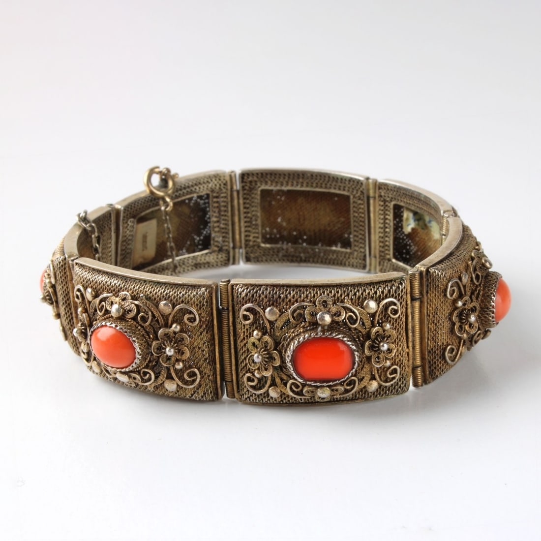Vintage Filigree and Coral Bracelet: Vintage Filigree Gilded Silver and Coral Bracelet. Stamped "SILVER" on clasp. Measures: 7-1/4" long, 3/4" wide. Total approximate gross weight: 1.34 troy ounces. Kodner Galleries offers phone and