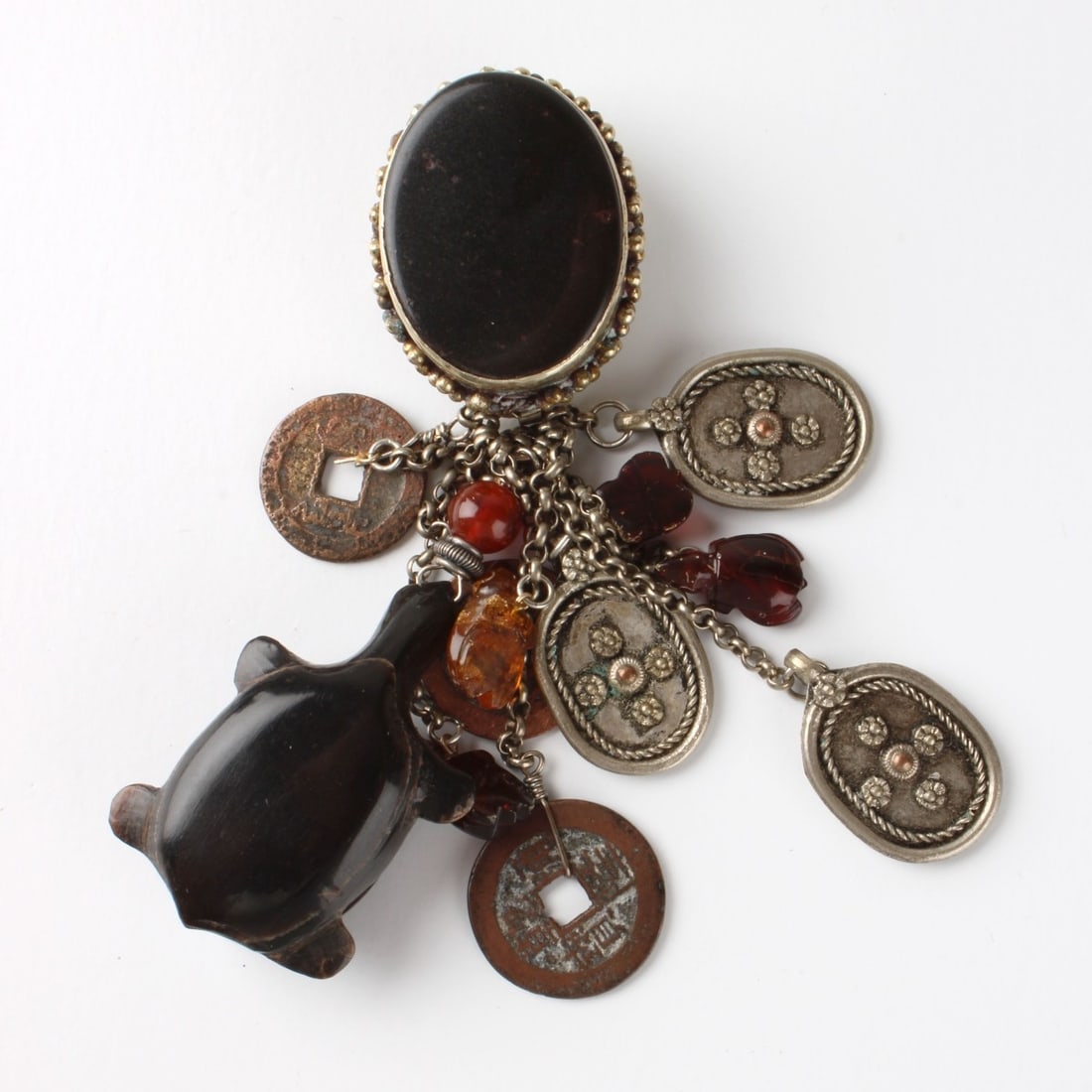 Chatelaine: Antique style White Metal Chatelaine with Attached Carved Horn Turtle Form Pill Box and Carved Amber Turtles and Metal Charms. Top section with black onyx. Overall measures 5" L, 1-1/4" W. Approx.