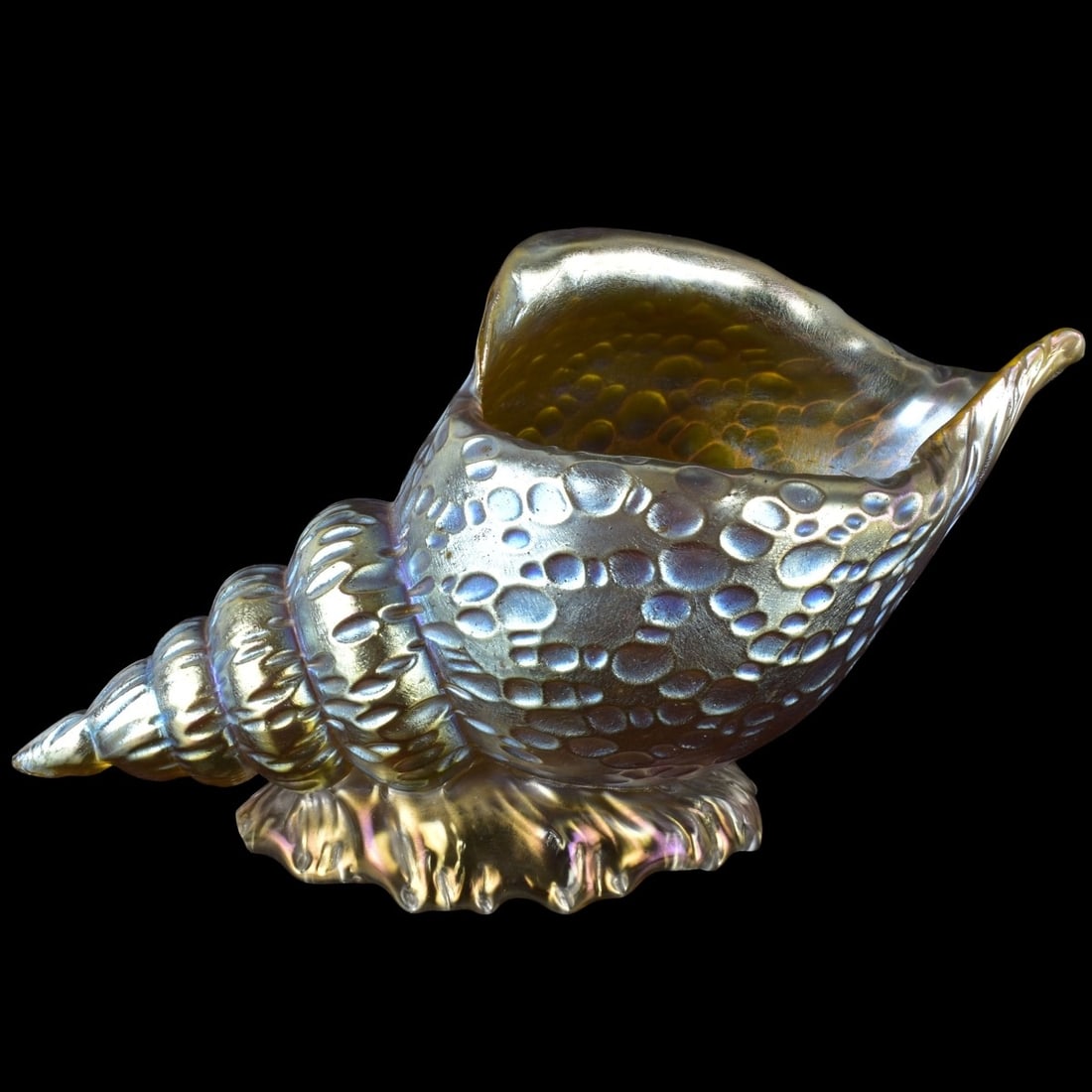 Loetz Art Nouveau Art Glass: Loetz Iridescent Conch Shell Art Glass Vase with an Oil Spot Design. Measures: 6" high, 11": long, 4-3/4" wide. Kodner Galleries offers phone and absentee bidding at a low, flat 21% buyer’s premium