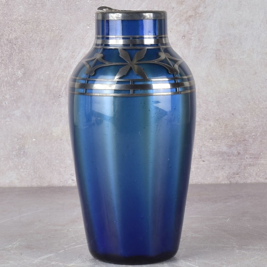 Loetz Art Nouveau Art Glass: Loetz Silver Overlaid Art Glass Vase with a Floral Pattern. Measures: 6-3/4" high, 3-1/4" diameter. Kodner Galleries offers phone and absentee bidding at a low, flat 21% buyer’s premium without