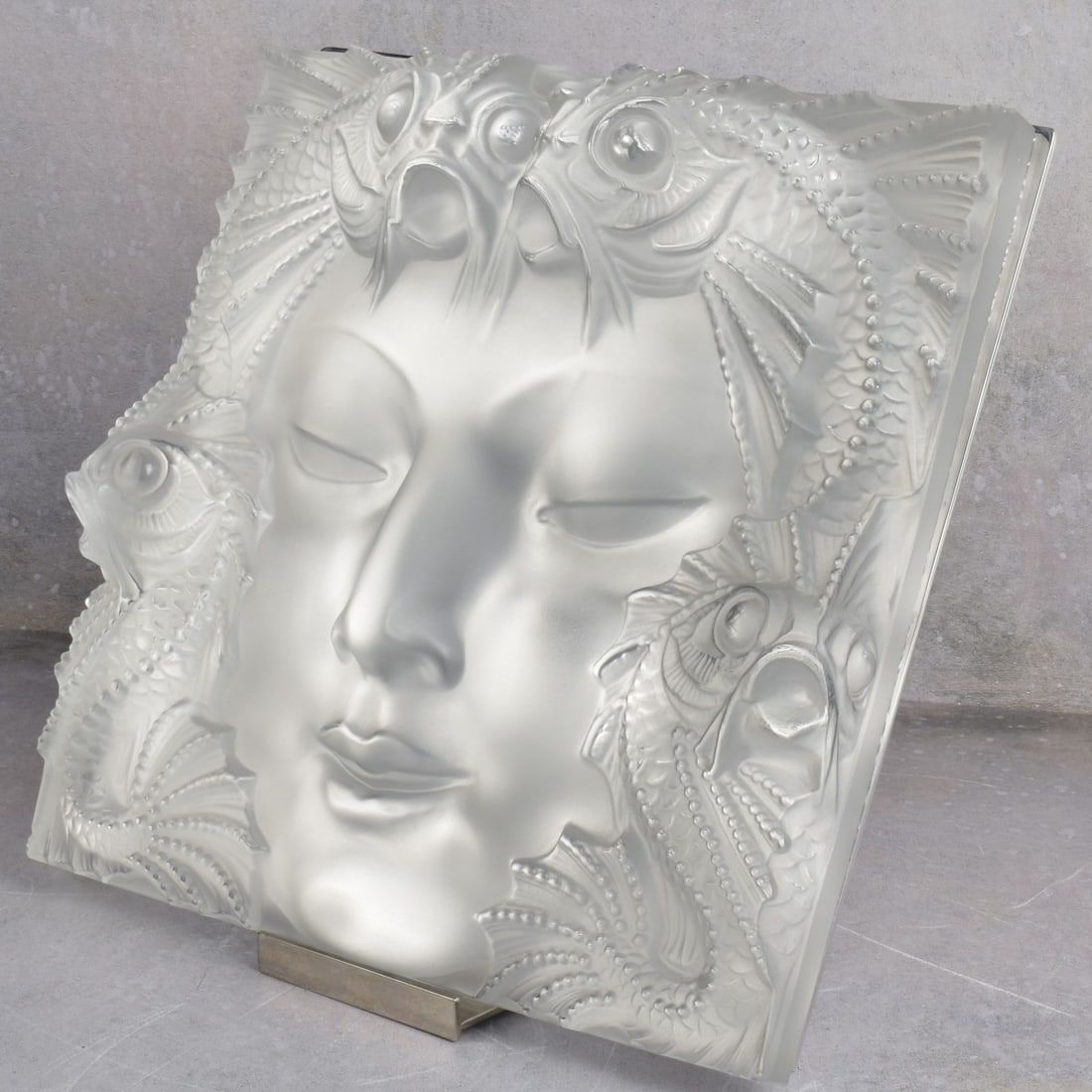 Lalique "Masque De Femme" Mask: Lalique "Masque De Femme" Frosted Crystal Mask. In the form of a woman's face with two Koi fish at the top of her face and another two Koi fish towards the bottom of the face, presented with its