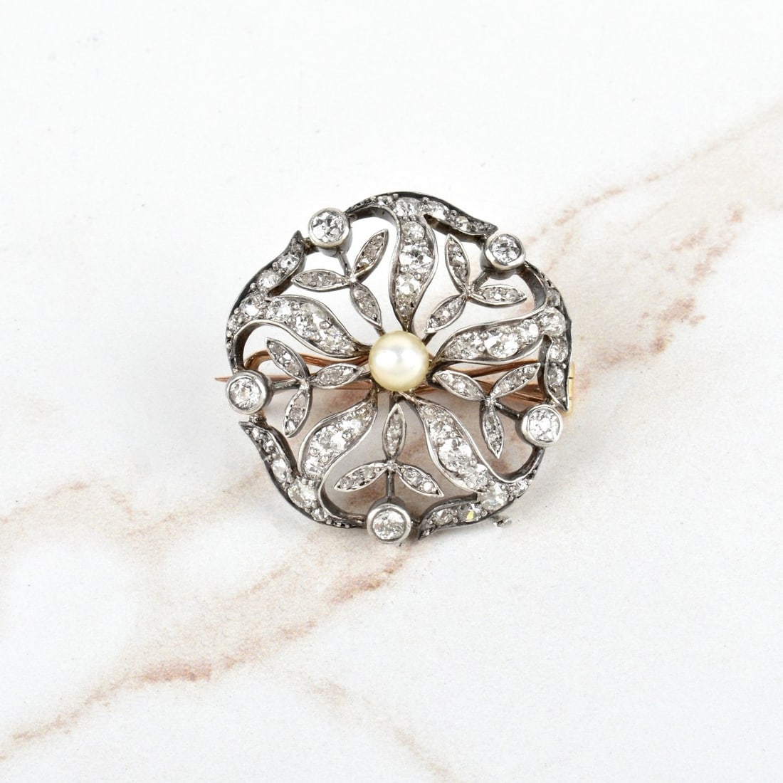 Diamond, Pearl, 14K Gold and Silver Pin: Antique Art Nouveau Approx. 2.0 Carat TW Old Mine Cut Diamond, Pearl, 14 Karat Yellow Gold and Silver "Snowflake" Pin. Measures 1-1/8" diam. Approx. weight: 8.90 grams. Kodner Galleries offers phone