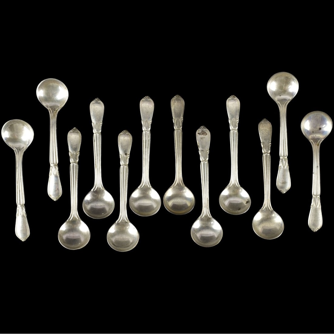 Frank W. Whiting Salt Spoons: Twelve (12) Frank W. Whiting Salt Spoons Stamped with the Company as well as marked "STERLING". Measures: 2-1/4" long. Total weight: 37.90 grams. Kodner Galleries offers phone and absentee bidding at