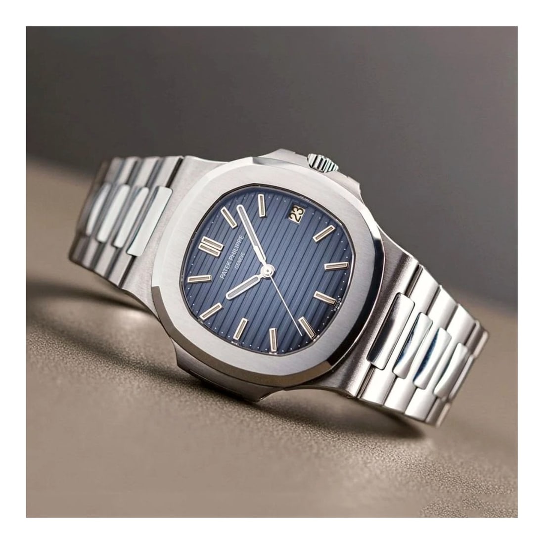 Patek Philippe 5711/1A: Patek Philippe 6711/1A Stainless Steel Bracelet Watch, Blue Dial. Automatic self-winding movement. Case measures 40mm. Complete with box and papers. Kodner Galleries offers phone and absentee bidding