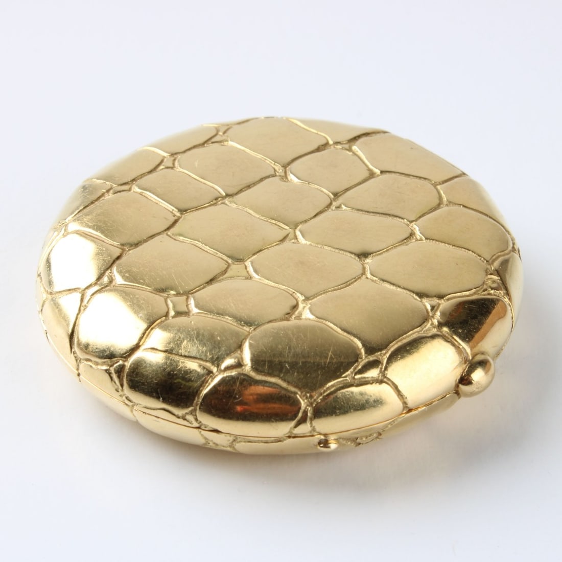 Tiffany & Co 18K Compact: Vintage Tiffany & Co Made in Italy 18 Karat Yellow Gold Compact with Alligator Skin Design. Signed "Italy Tiffany". Measures 2" diam. Approx. gross weight: 55.45 grams. Kodner Galleries offers phone