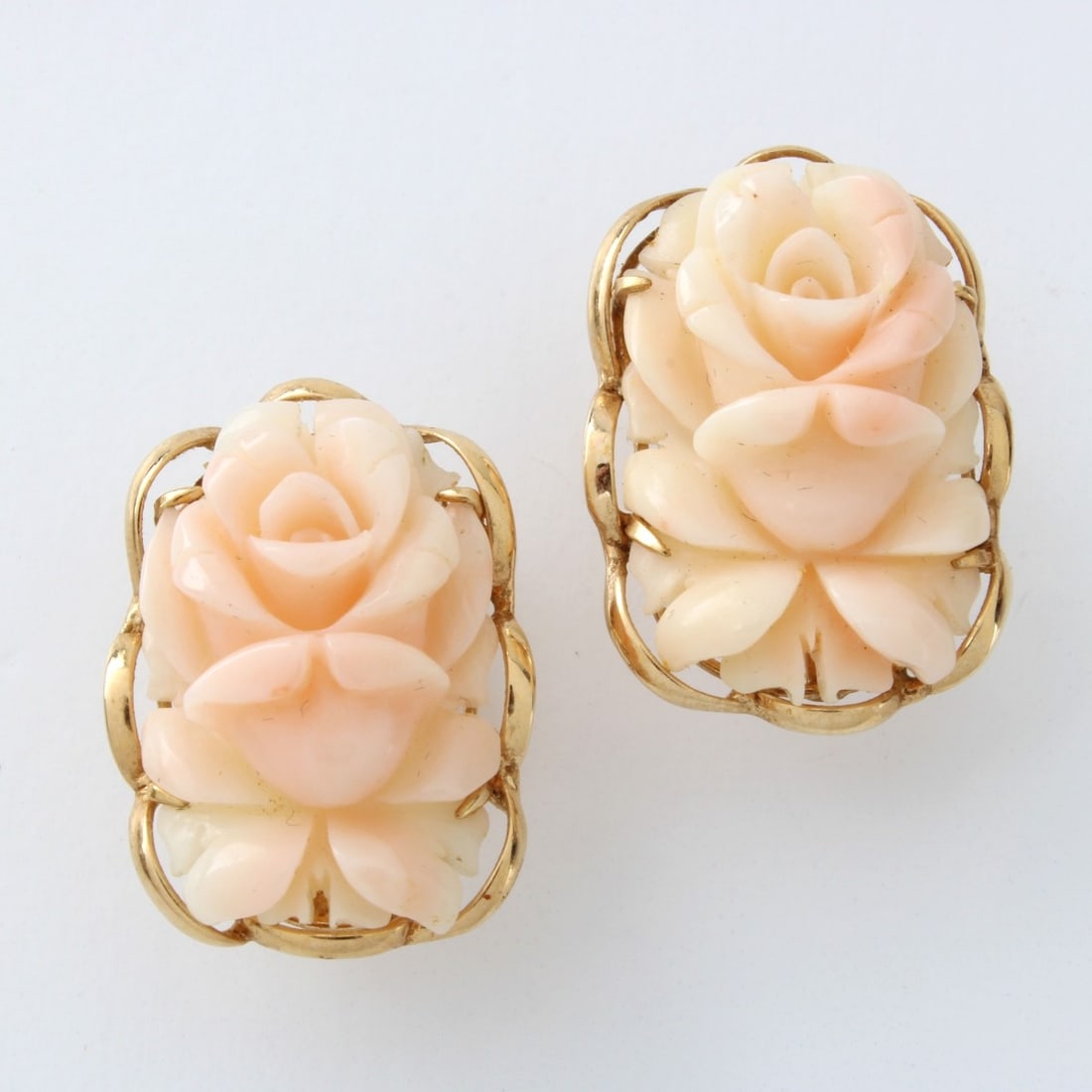 Coral and 14K Earrings: Vintage Carved Angel Skin Coral Flower and 14 Karat Yellow Gold Earrings. Stamped 14K. Measure 1" L, 3/4" W. Approx. weight: 9.76 grams. Kodner Galleries offers phone and absentee bidding at a low,