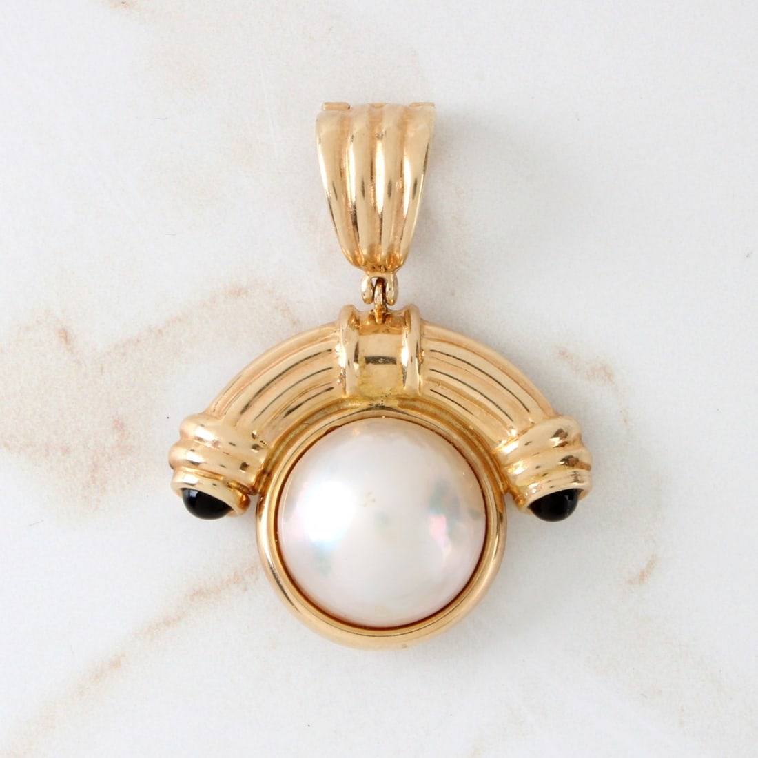 Pearl, Onyx and 14K Pendant: Vintage 15mm Mabe Pearl, Black Onyx and 14 Karat Yellow Gold Pendant. Pearl with good luster and polish. Stamped 14K. Measures 1-1/2" L, 1-1/4" W. Approx. weight: 7.97 grams. Kodner Galleries offers