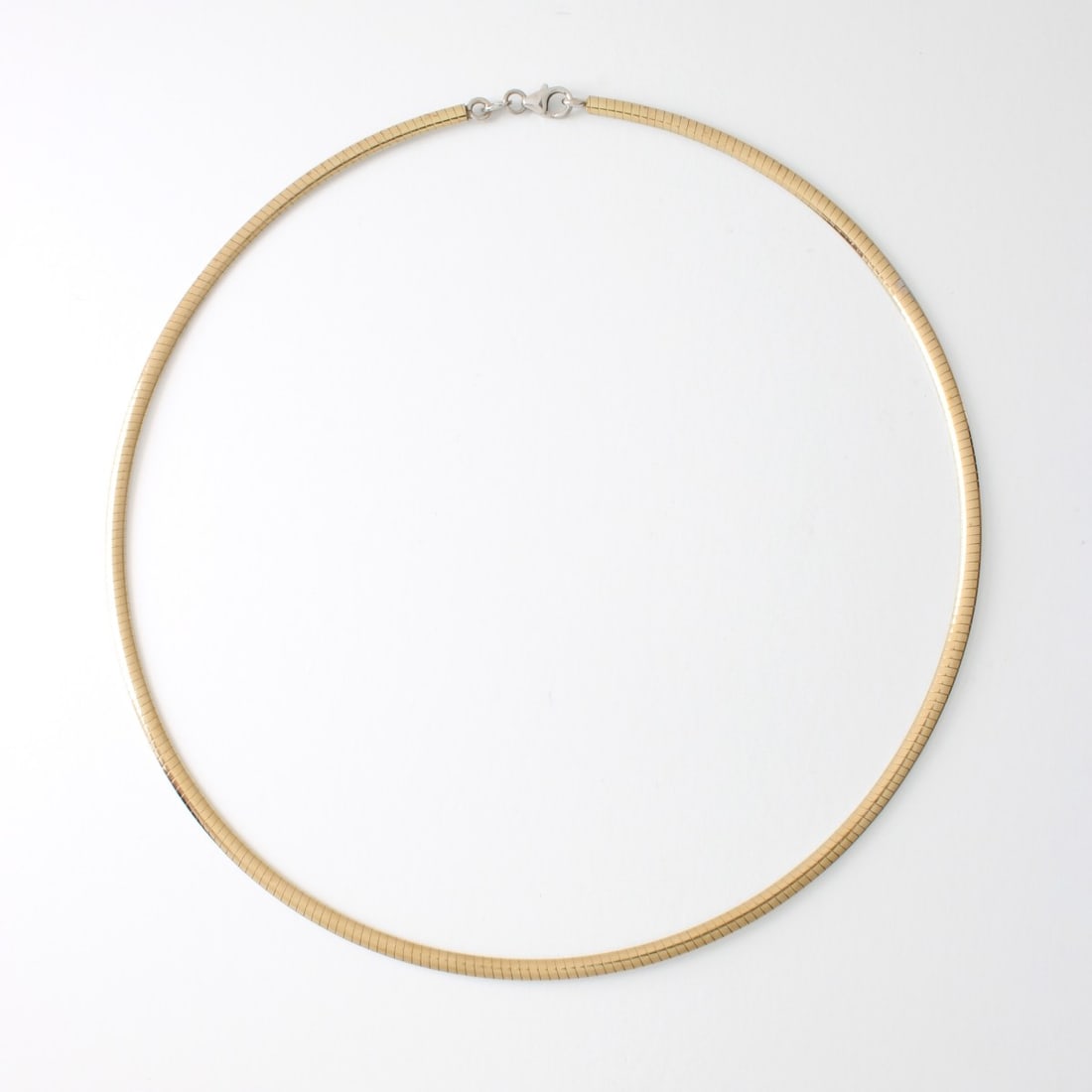 14K Omega Necklace: Vintage Italian 14 Karat Yellow / White Gold Reversible Omega Necklace. Stamped Italy 14K to clasp. Measures 16" L, 3mm W., Approx. weight: 13.54 grams. Kodner Galleries offers phone and absentee