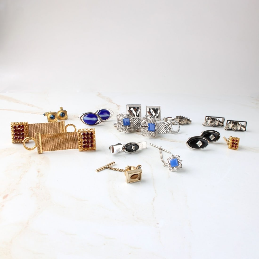 Vintage Cufflinks and Tie Clips: Vintage Assortment of Cufflinks and Tie Clips. Including four (4) sets of cufflinks and tie clips, three (3) sets of cufflinks, one (1) tie cup pin. Kodner Galleries offers phone and absentee bidding