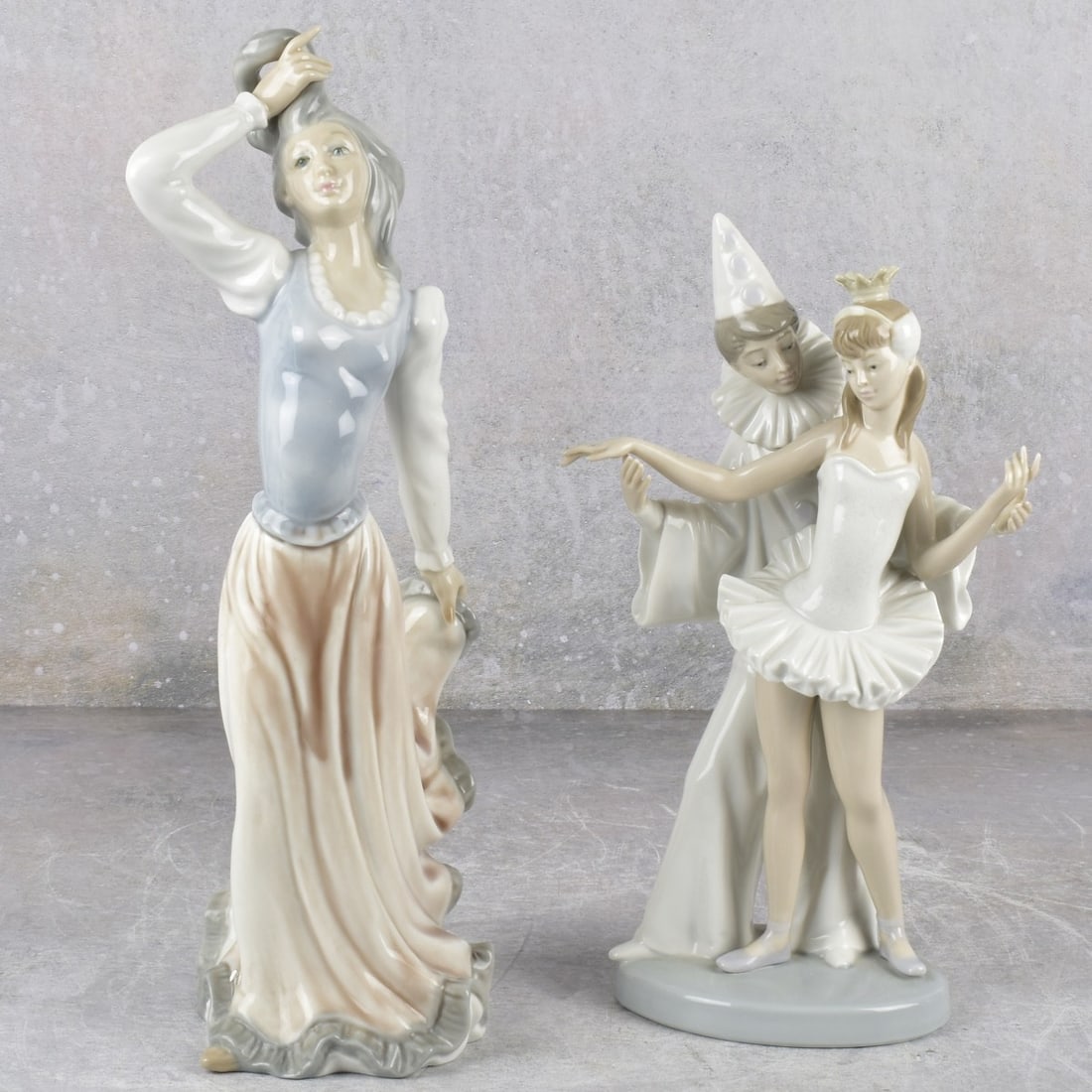 Lladro and Guerra San Martin Sculptures: Two (2) Porcelain Sculptures. Consisting of one (1) Lladro Spain "Carnival Couple" Glossy Porcelain Sculpture of a Young Ballerina and a Young Pierrot Dancing Together. Stamped to underside.