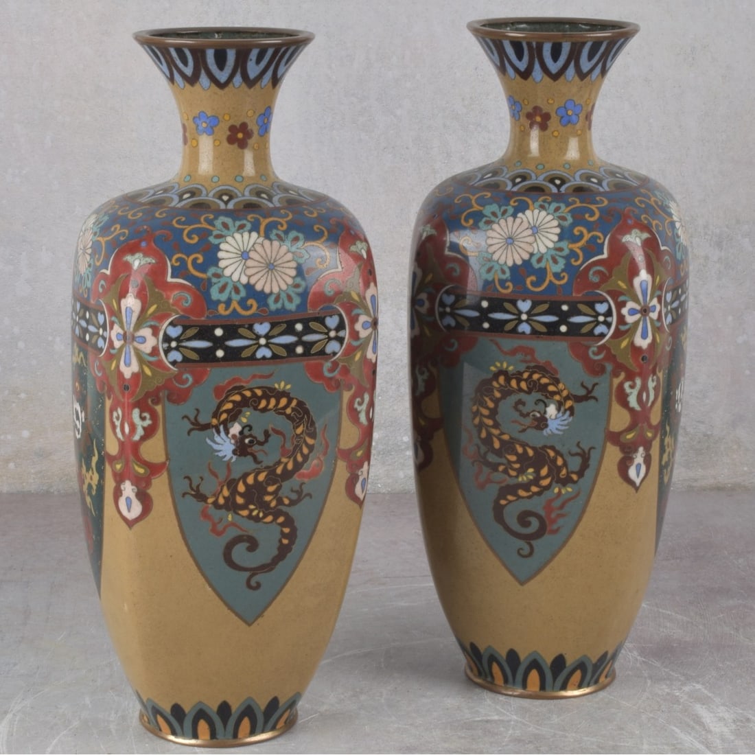 Japanese Cloisoinne Vases: Pair of Japanese Cloisonne Four Sided Vases on Copper. 19th/20th century. Decorated with dragons, phoenix birds scrolls and flowers with large medallions on silver foil shields. Measures: 12" high, 4-