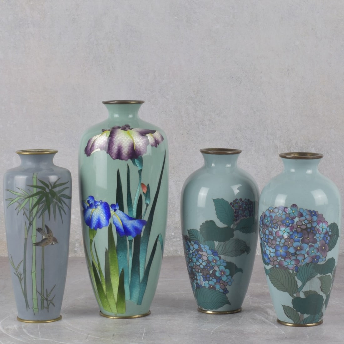 Japanese Cloisonne Vases: Four (4) Japanese Cloisonne Vases on Copper. 19th/20th century. Consisting of a pair of vases decorated with lilacs on silver foil, measures: 7-1/8" high, 3" diameter, one slender vase decorated with