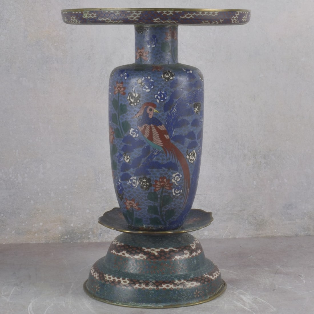 Japanese Cloisonne Usabata Ikebana Vase: Vintage Japanese Cloisonne Usabata Ikebana Vase. Four sections decorated with flora motifs, large phoenix birds and clouds. Measures: 16-3/4" high, 11" diameter. Kodner Galleries offers phone and