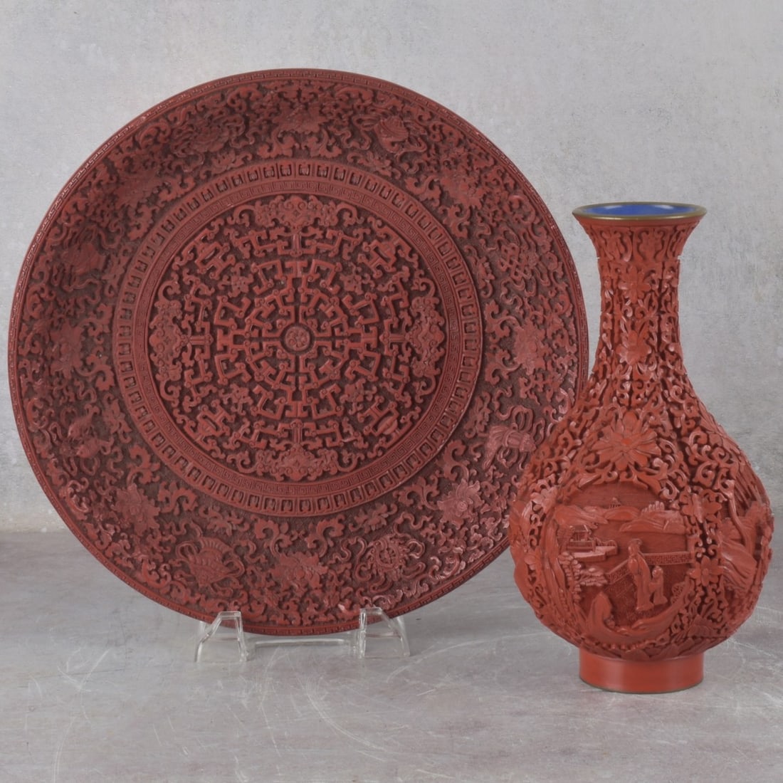 Vintage Chinese Cinnabar: Vintage Chinese Cinnabar Type Pieces. Consisting of one vase on copper decorated with figures and flowers, measures: 8-3/4" high, 4-1/2" diameter, one plate measures: 11-1/4" diameter. Kodner