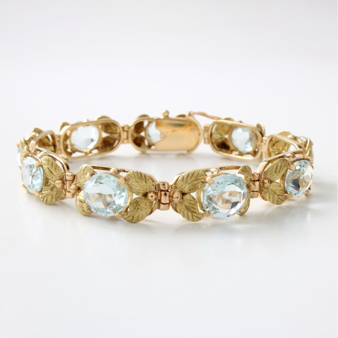 H Stern Aquamarine and 18K Bracelet: Vintage H Stern Approx. 19.0 Carat TW Nine (9) Oval Cut Aquamarine and 18 Karat Yellow Gold Link Bracelet. Signed (logo) and stamped 750. Measures 7-1/4" L, 3/8" W. Approx. weight: 24.07 grams.