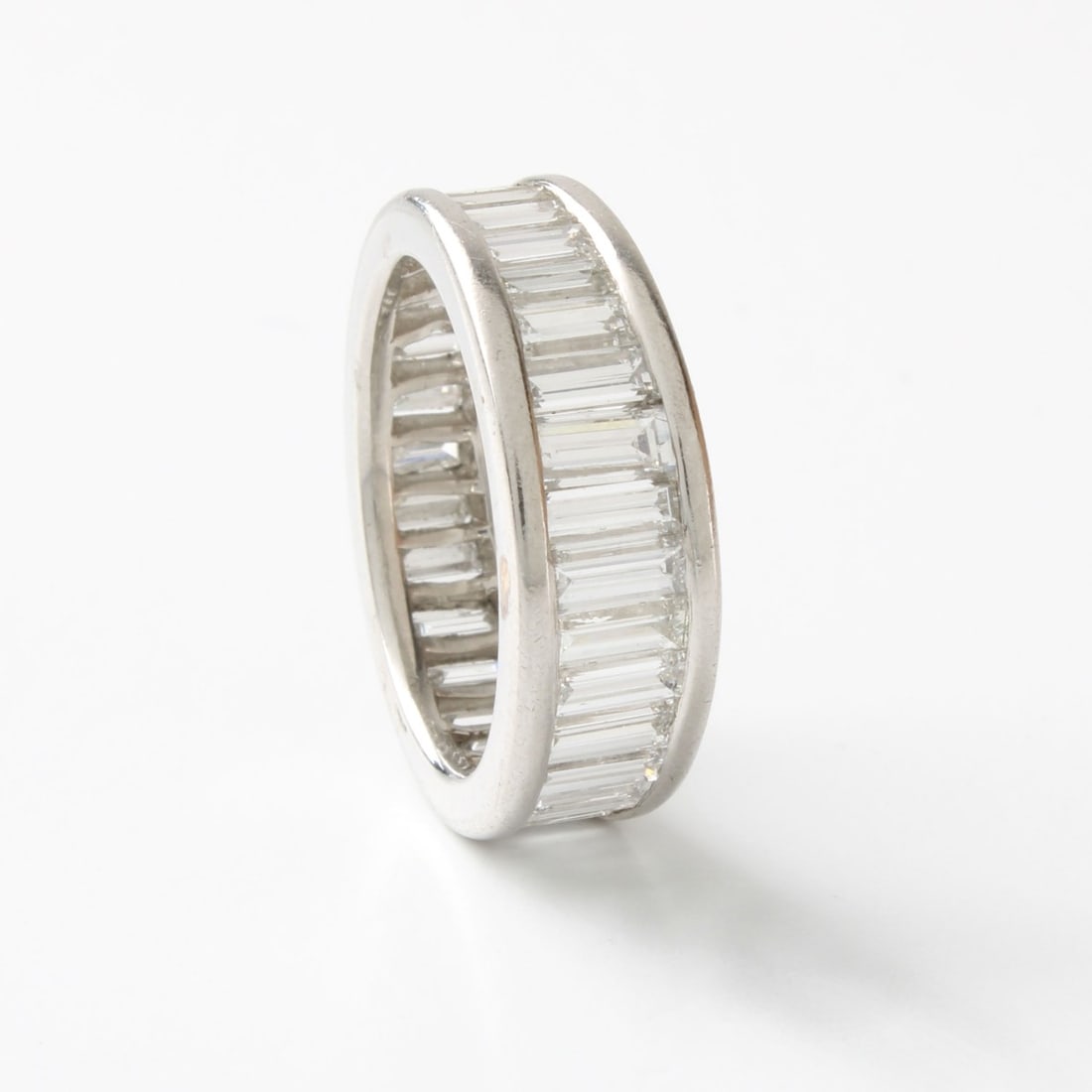 Diamond and Platinum Eternity Band: Vintage Approx. 4.0 Carat TW Baguette Cut Diamond and Platinum Eternity Band / Ring. Diamonds E-F color, VVS clarity. Ring size 6. Approx. weight: 7.70 grams. Kodner Galleries offers phone and
