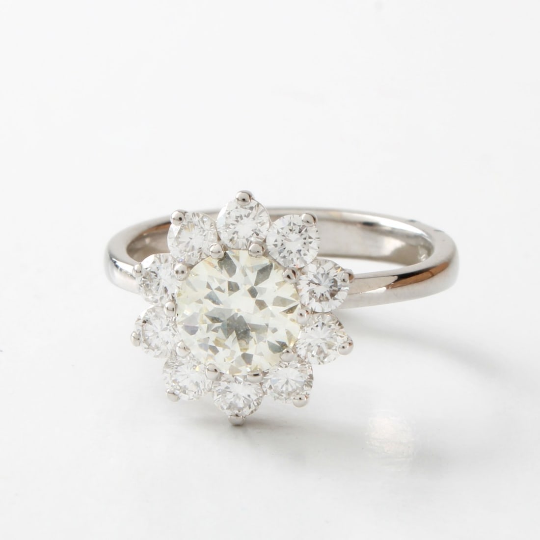 Diamond and 18K Ring: Vintage Diamond and 18 Karat White Gold Ring. Set in the center with an approx. 1.01 carat old European cut diamond, H-I color, VS clarity and accented with ten round brilliant cut diamonds weighing