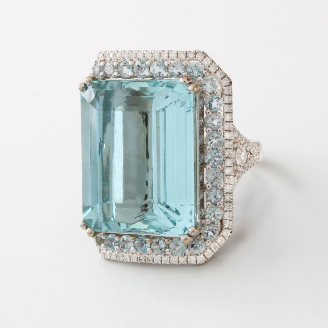 Aquamarine, Diamond and 18K Ring: Very Fine Aquamarine, Diamond and 18 Karat White Gold Ring. Set in the center with an approx. 35.0 carat octagonal step cut gem quality aquamarine and accented with 2.0 carat TW round cut aquamarines
