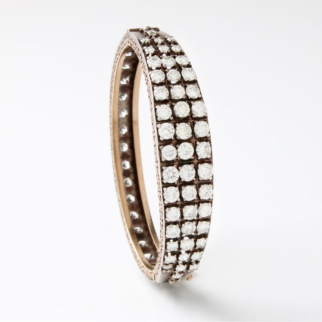 Diamond, Platinum and 18K Bracelet: Antique Approx. 9.0 Carat TW Round Brilliant Cut Diamond, Platinum and 18 Karat Yellow Gold Cuff Bangle Bracelet. Diamonds H-I color, VS-SI clarity. Measures 5-3/4" interior circumference. Approx.