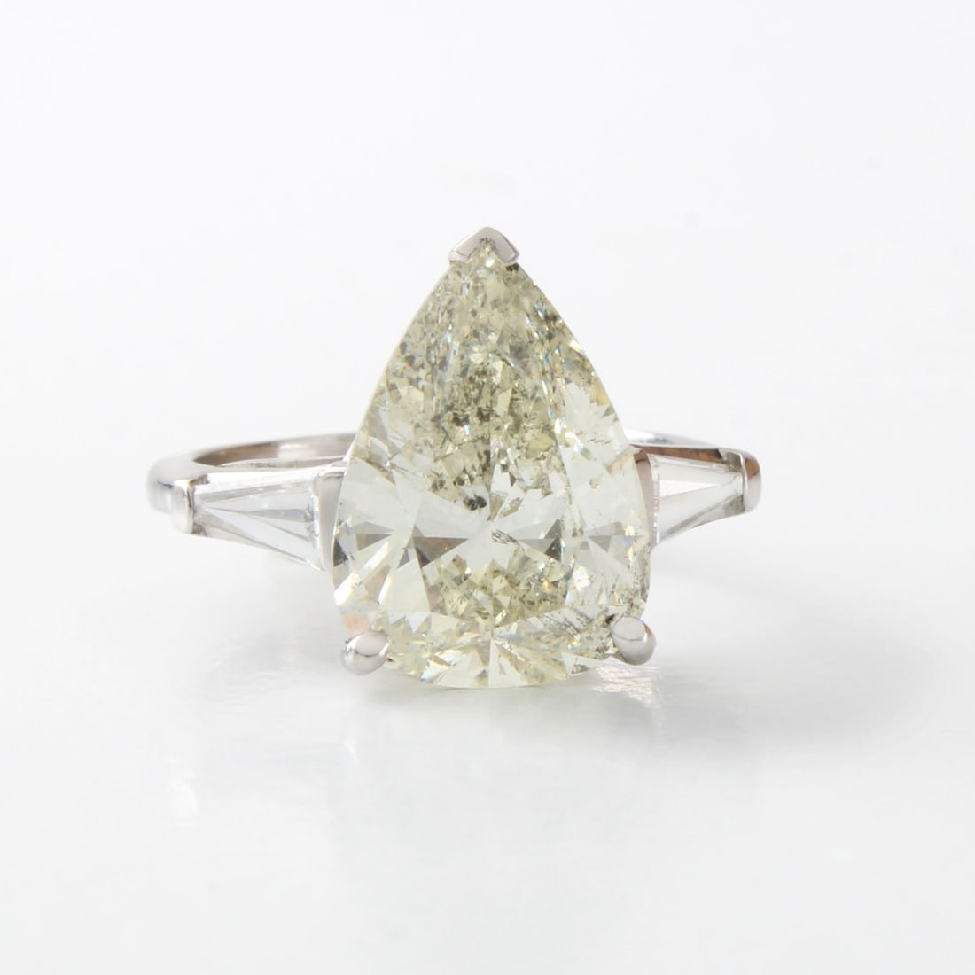 EGL Diamond and Platinum Ring: Vintage Diamond and Platinum Engagement Ring. Set in the center with an EGL certified 5.0 carat pear shape diamond and accented with .40 carat TW two tapered baguette cut diamonds. Center diamond J