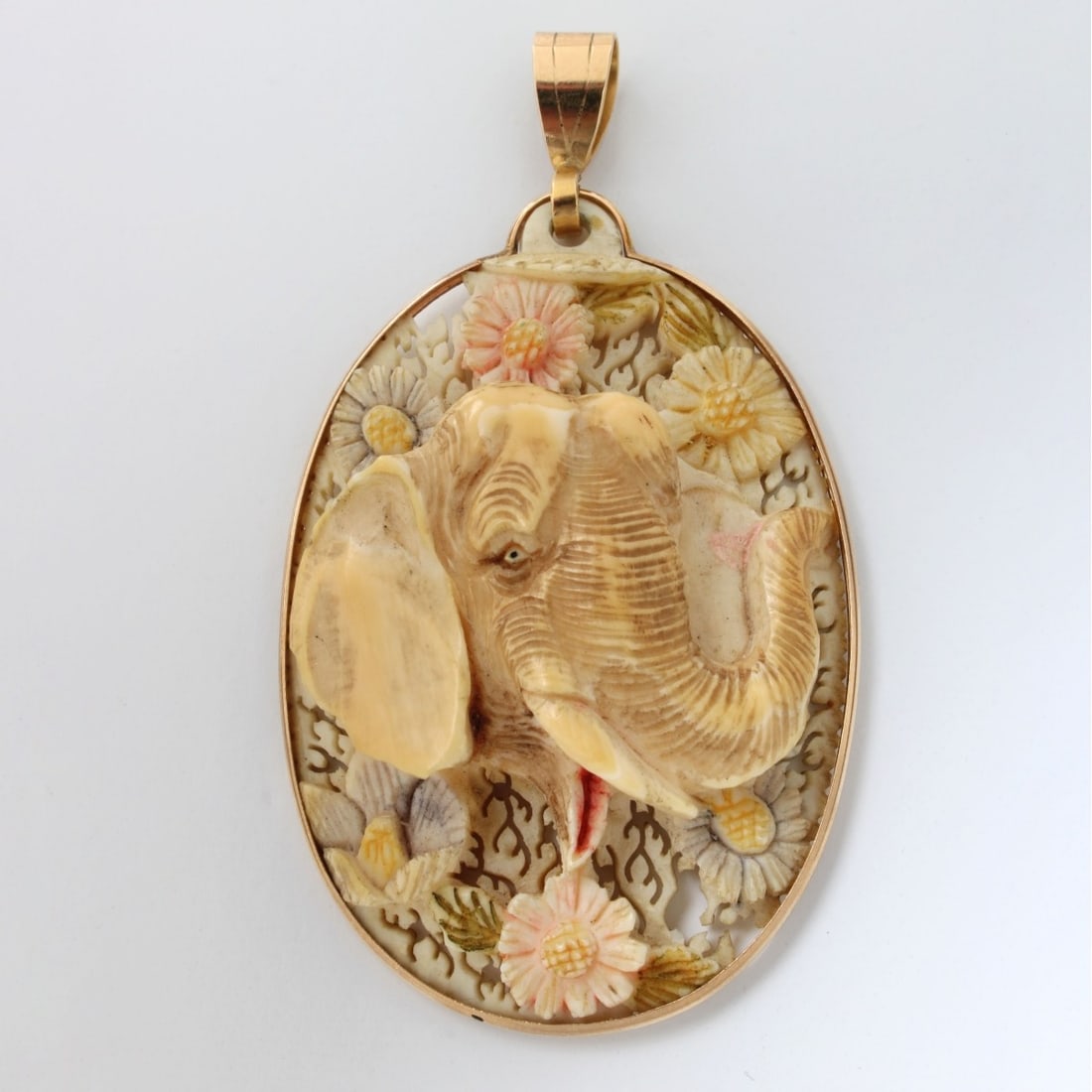 14K Mounted Flower Pendant: Vintage 14 Karat Yellow Gold Mounted Finely Carved Relief Polychrome Elephant and Flower Pendant. Stamped 14K. Measures 2-3/4" L, 1-1/2" W. Approx. weight: 15.76 grams. We Will Not Ship This Item