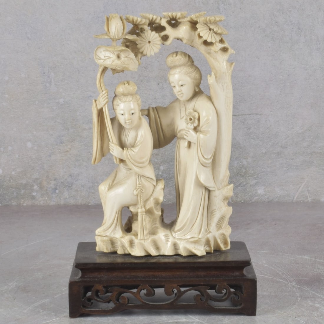 Antique Chinese Carved Sculpture: Antique Carved Chinese Sculpture of Two Women Under a Lotus Tree Mounted to a Carved Wood Base. Sculpture measures: 6-1/4" high, 3-1/4" wide, 1-1/2" deep, wood base measures: 1-1/2" high. Kodner