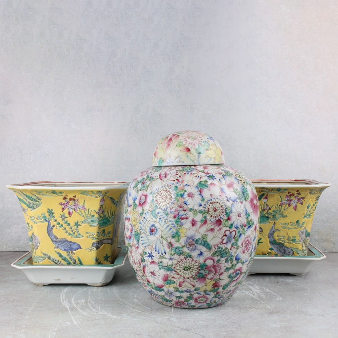 Vintage Chinese Porcelain Pieces: Vintage Chinese Porcelain Pieces. Consisting of a pair of Chinese famille rose planters, measures: 6" high, 8-1/8" wide, 8-1/8" deep, one mille fleur ginger jar, signed "Chien Lung" to the bottom,