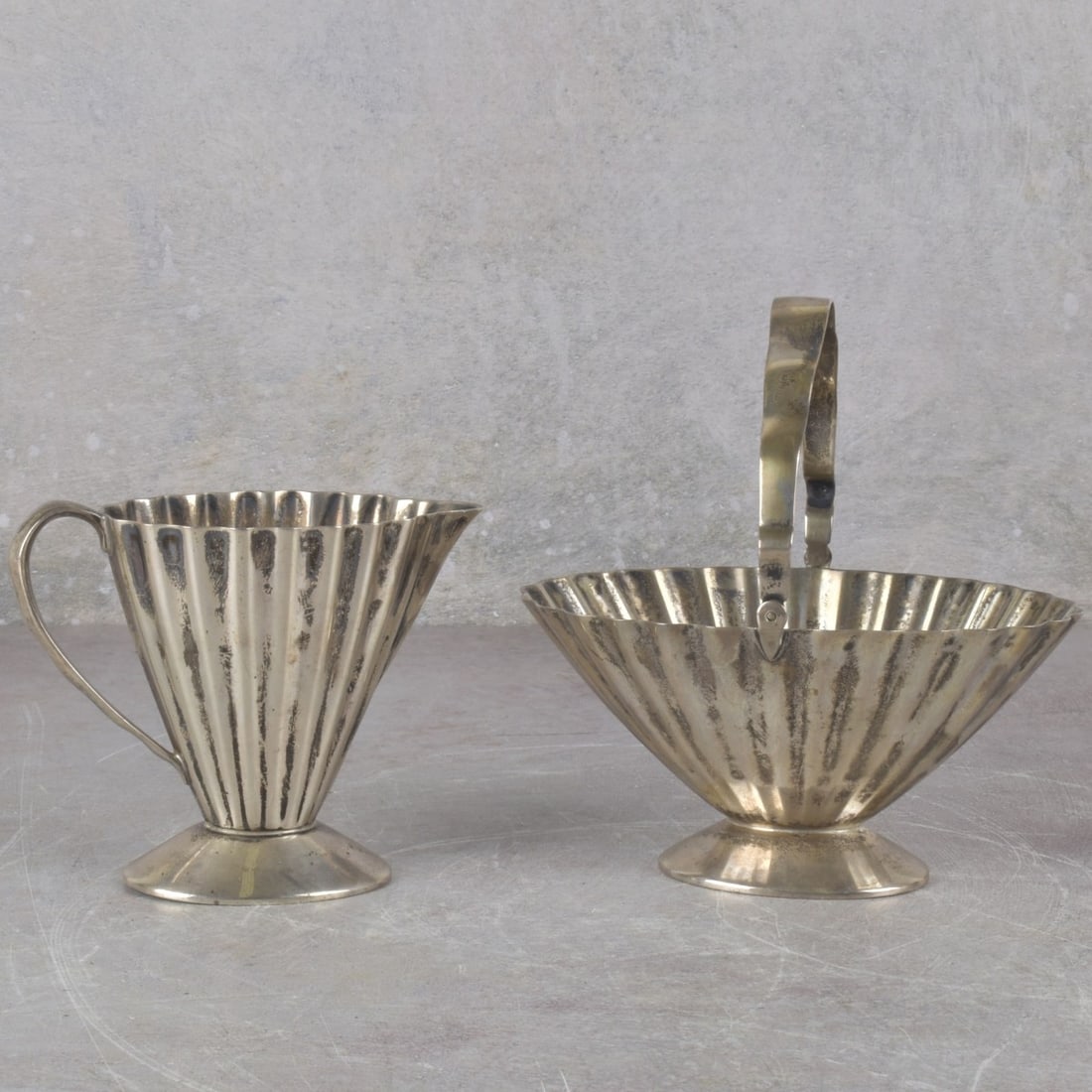 Reed and Barton Sterling Silver: Vintage Reed and Barton Sterling Silver. Including one (1) fluted open sugar footed oval basket with handle, stamped "STERLING 10" with the Reed and Barton logo, bowl measures: 2-1/2" high, 4-7/8"
